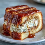 A close-up slice of Caramel Cream Cheese Bread reveals a decadent cream cheese center and sweet caramel ribbon for breakfast or dessert.