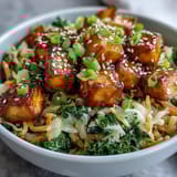 Fork-ready Tofu Egg Roll in a Bowl features sautéed kale, spinach, and ginger aromatics tossed in a glossy, savory umami sauce.