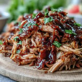 Enjoy smoky Juneteenth BBQ Pulled Pork piled high, perfect with watermelon slaw.