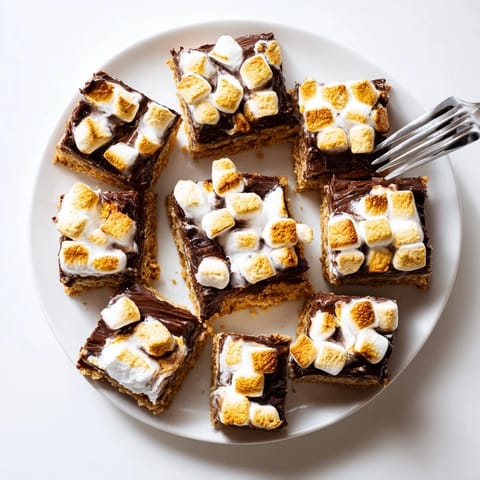 Freshly baked S'mores Bars with a toasted marshmallow topping and melted chocolate layer.