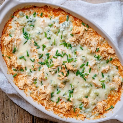 Freshly chopped chives top the creamy, cheesy dip, with crisp celery sticks and tortilla chips ready for scooping.