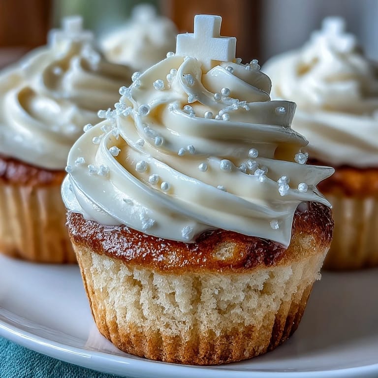 Sweet communion cupcakes topped with smooth buttercream and a pristine white fondant cross.