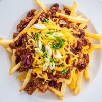 Crispy golden fries piled high, smothered in hearty beef chili and melted cheddar cheese.